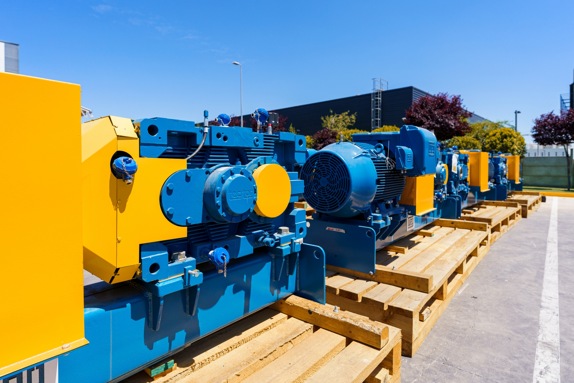 Industrial AC motors staged outdoors for DC motor replacement in a Canadian facility.