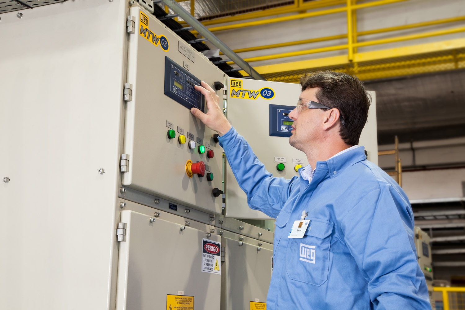 Technician configuring a VFD to convert a DC motor to an AC motor in an industrial facility.