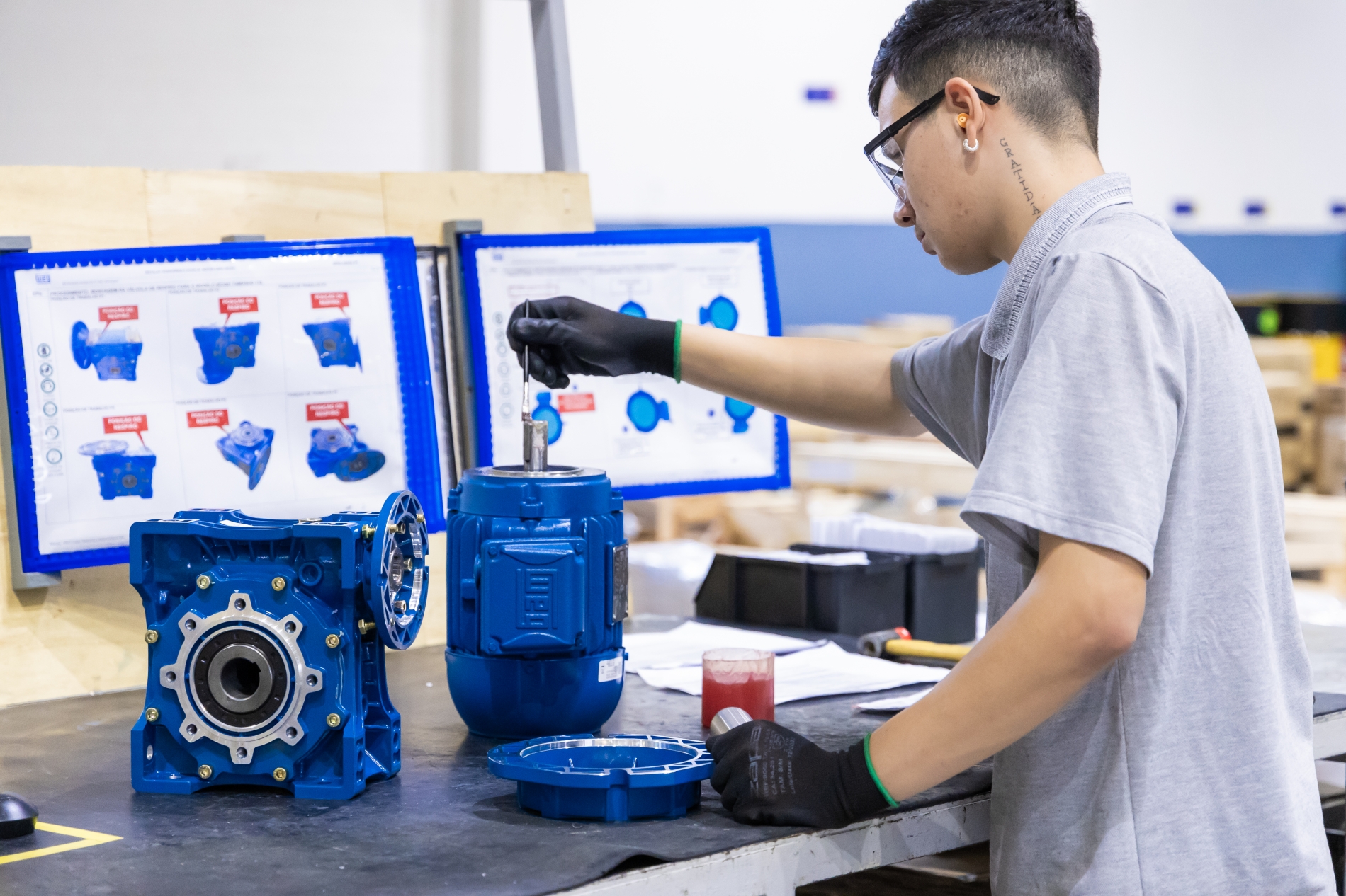 A technician assembles an industrial electric motor in a manufacturing facility, highlighting the precision and engineering behind electric motors used in industrial automation.