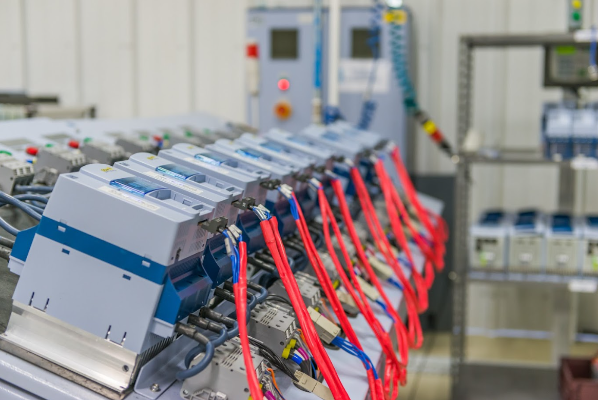 A high-tech industrial factory floor featuring large motors, automation equipment, and an organized workspace for efficient production.