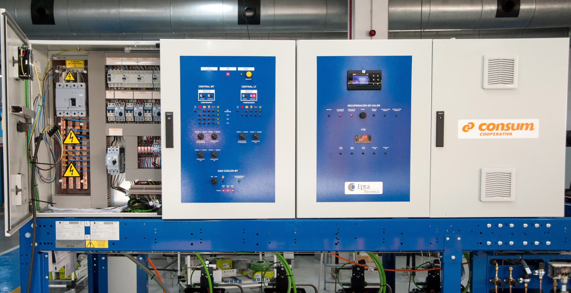 Industrial motor control panel with variable frequency drive components wired inside an electrical cabinet.