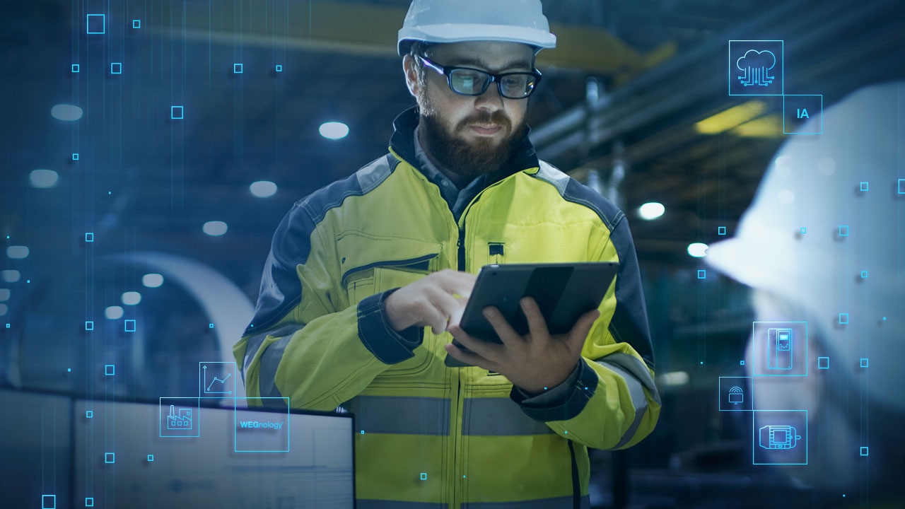 An engineer in a high-visibility jacket using a tablet to monitor motor performance in a smart factory, with digital automation icons overlayed.