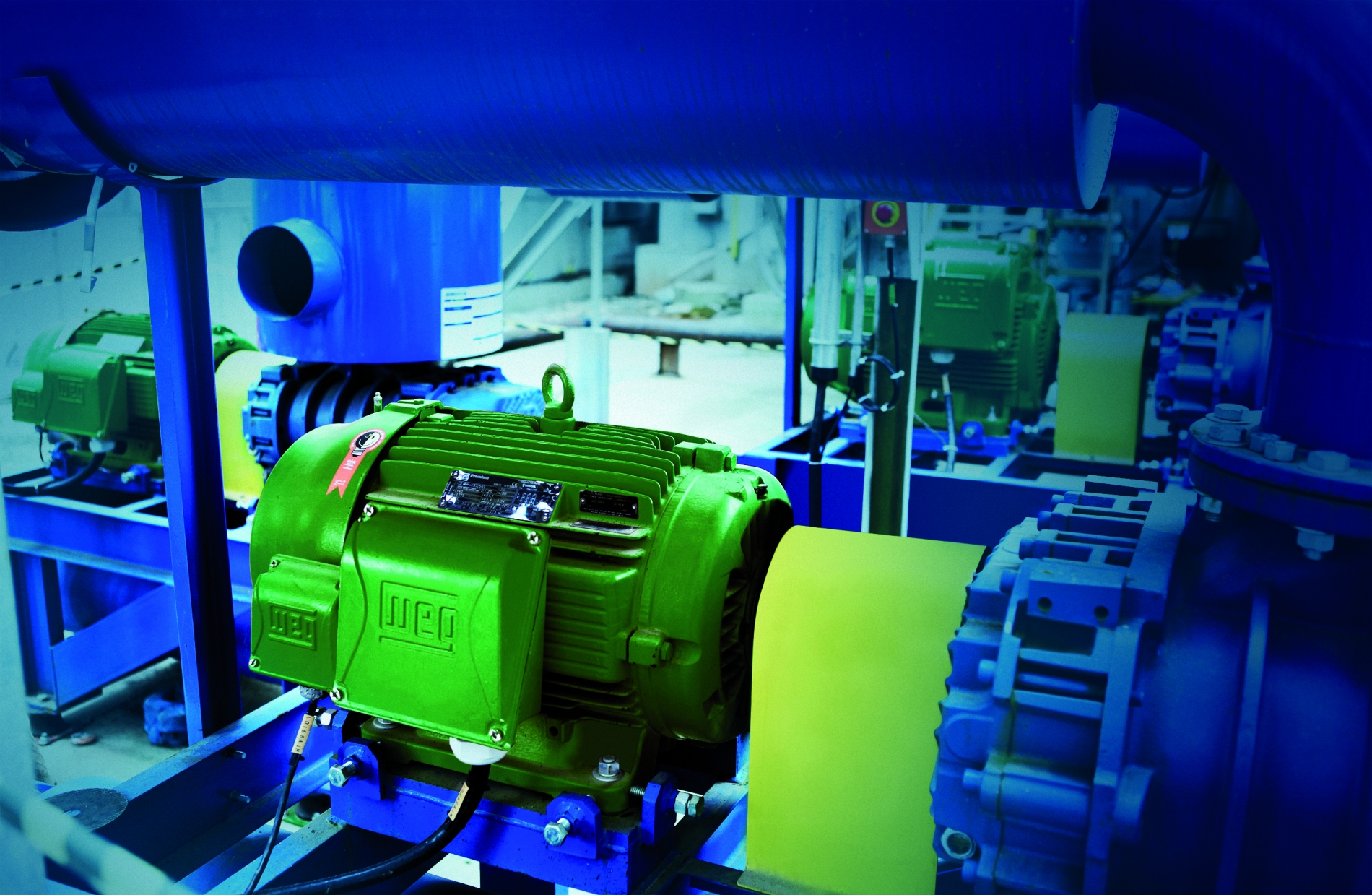 High-efficiency WEG W22 motors installed in an industrial facility, showcasing energy-efficient motor solutions for reducing operational costs.