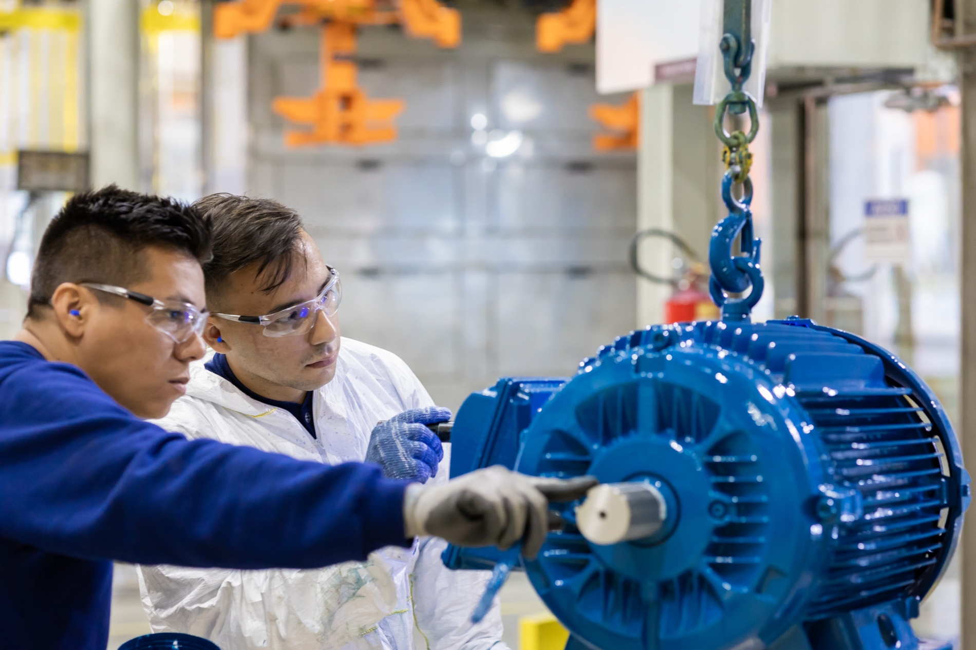 Two engineers performing commissioning checks on an electric motor before installation.