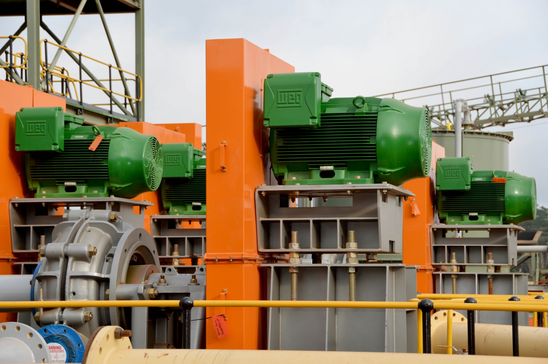 High-efficiency WEG motors mounted on industrial equipment at an outdoor facility.
