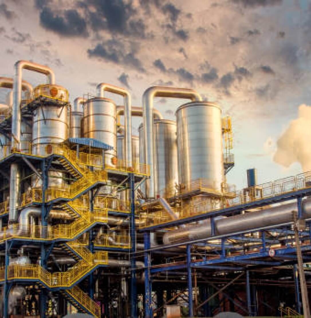 Large tanks shown outside of sugar and ethanol processing plant